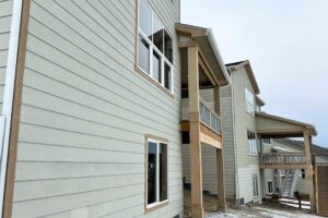 Newly installed fiber cement lap siding on a two-story home exterior