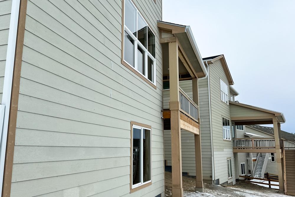 Newly installed fiber cement lap siding on a two-story home exterior